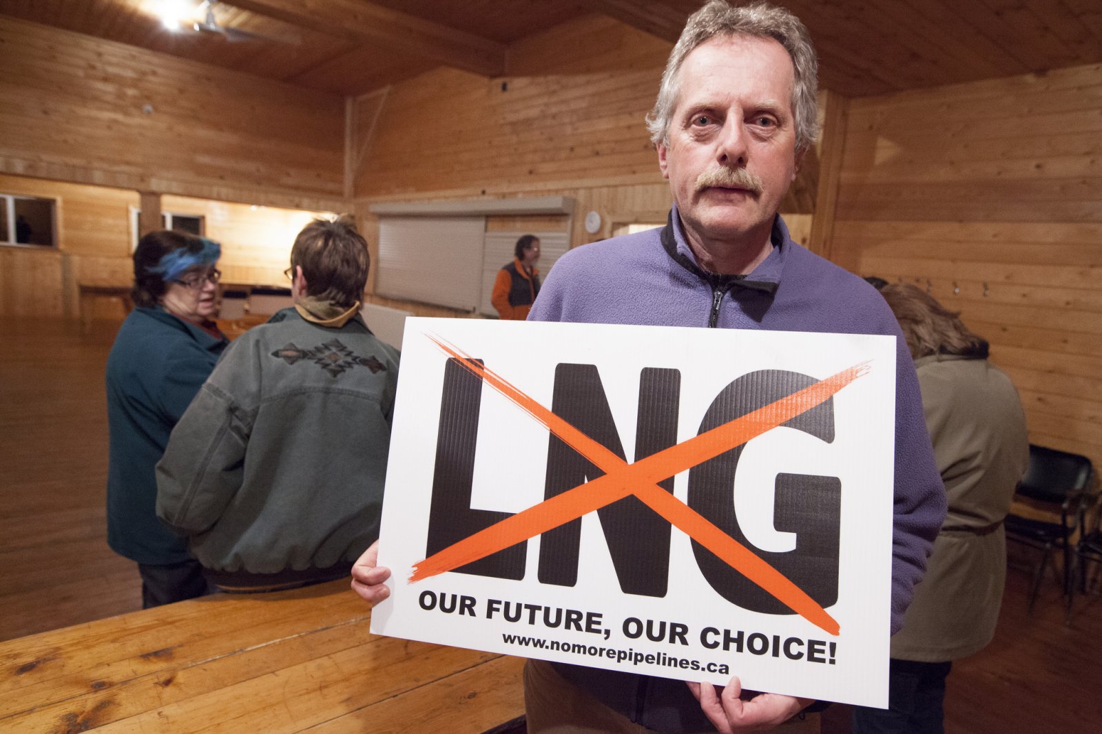 Paramedic Graeme Pole holding a "No LNG" sign seen on lawns and road sides throughout the Kispiox Valley - Photo by Mychaylo Prystupa