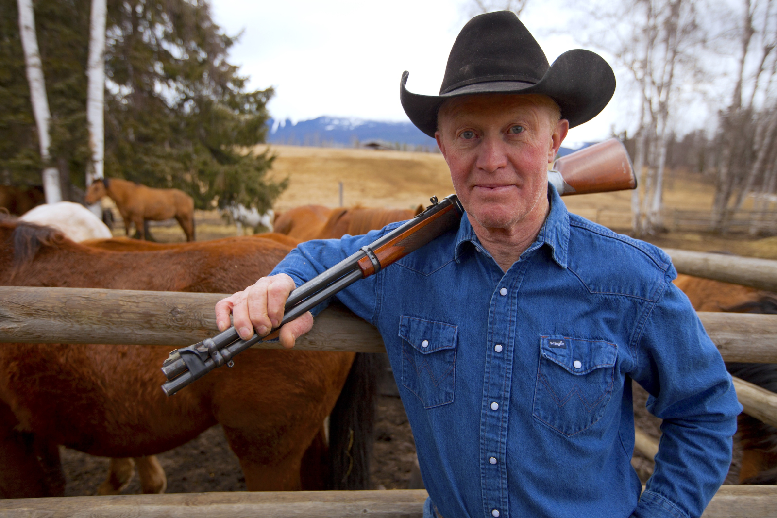 Rancher and lodge owner Gene Allen holding his gun near Hazelton B.C. opposes LNG - photo by Mychaylo Prystupa