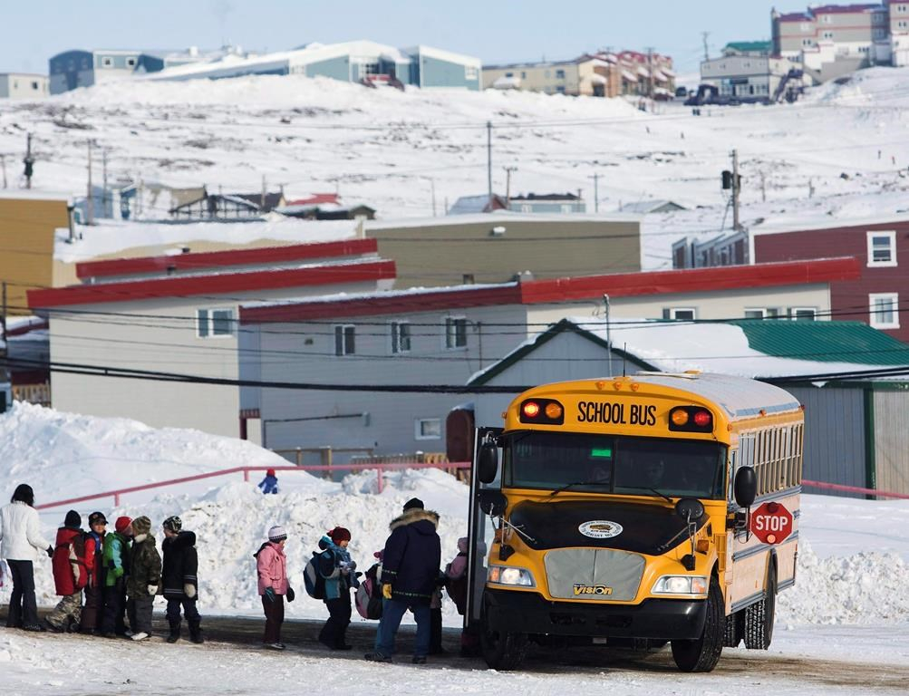 Students board a school bus at the Nakasuk Elementary School in Iqaluit, Nunavut, in a March 30, 2009, file photo.