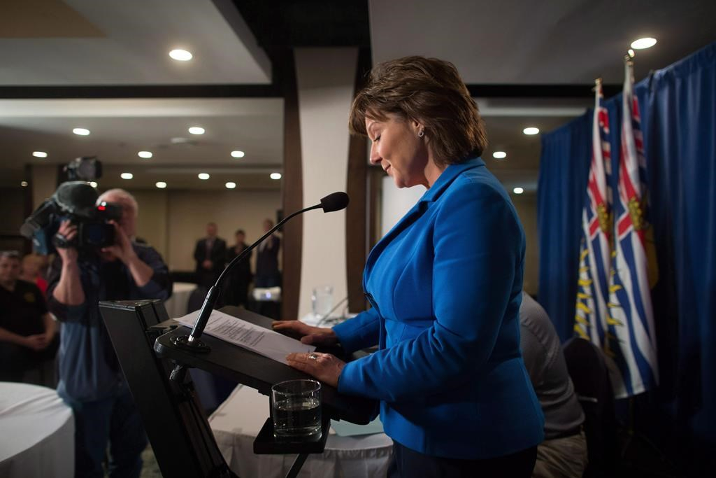 British Columbia Premier Christy Clark pauses to read her notes while addressing MLAs during a caucus meeting at a hotel in Vancouver on May 16, 2017.