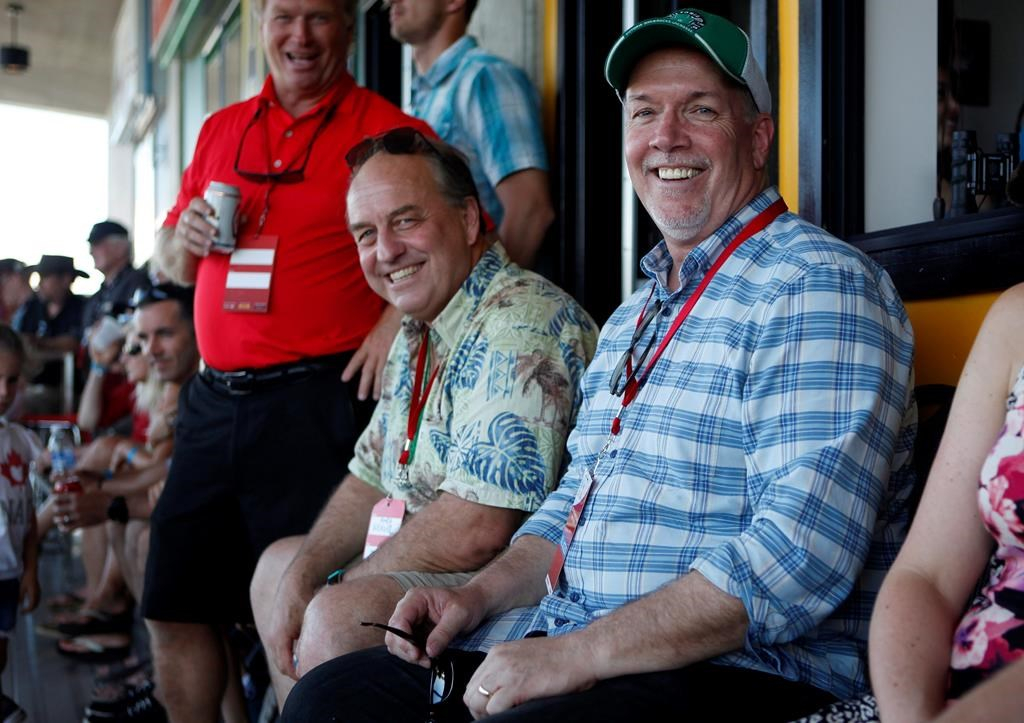 B.C. Green party leader Andrew Weaver and B.C. NDP leader John Horgan take in the final match between Team Canada and New Zealand during cup final action at the HSBC Canada Women's Sevens at Westhills Stadium in Langford, B.C., on May 28, 2017.