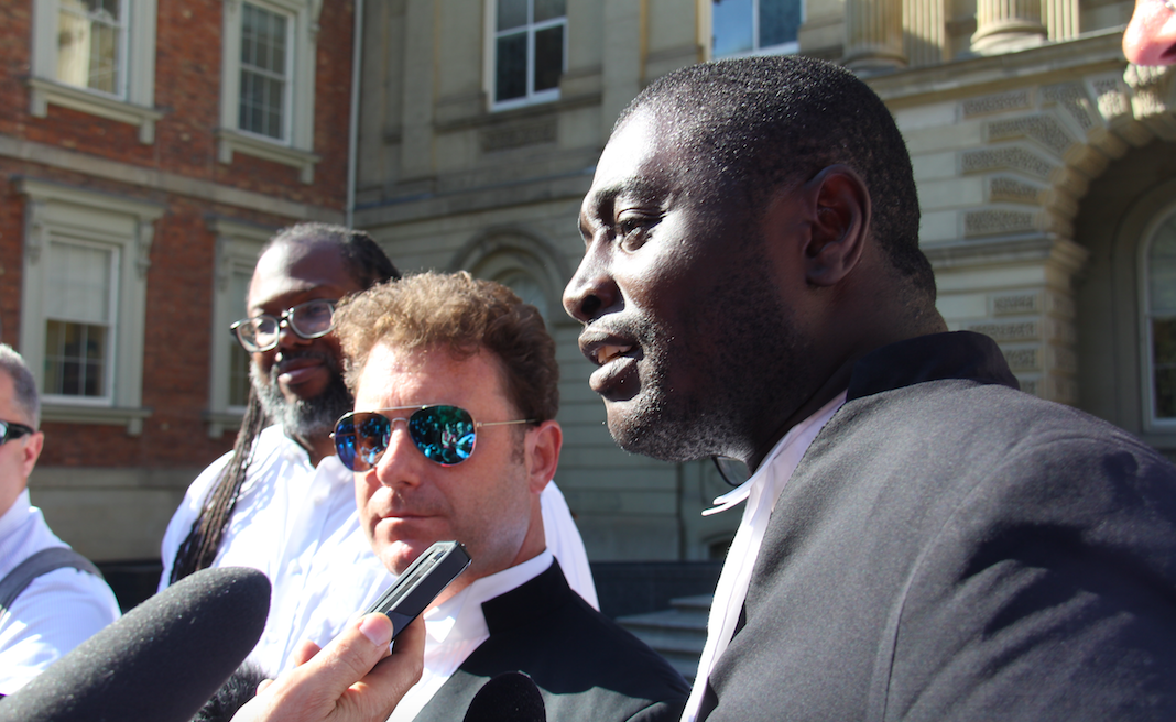 City council candidate Rocco Achampong, right, and his legal counsel Gavin Magrath, centre, speak to media following Court of Appeal hearings in Toronto on Tuesday, Sept. 18, 2018. Photo by Steph Wechsler