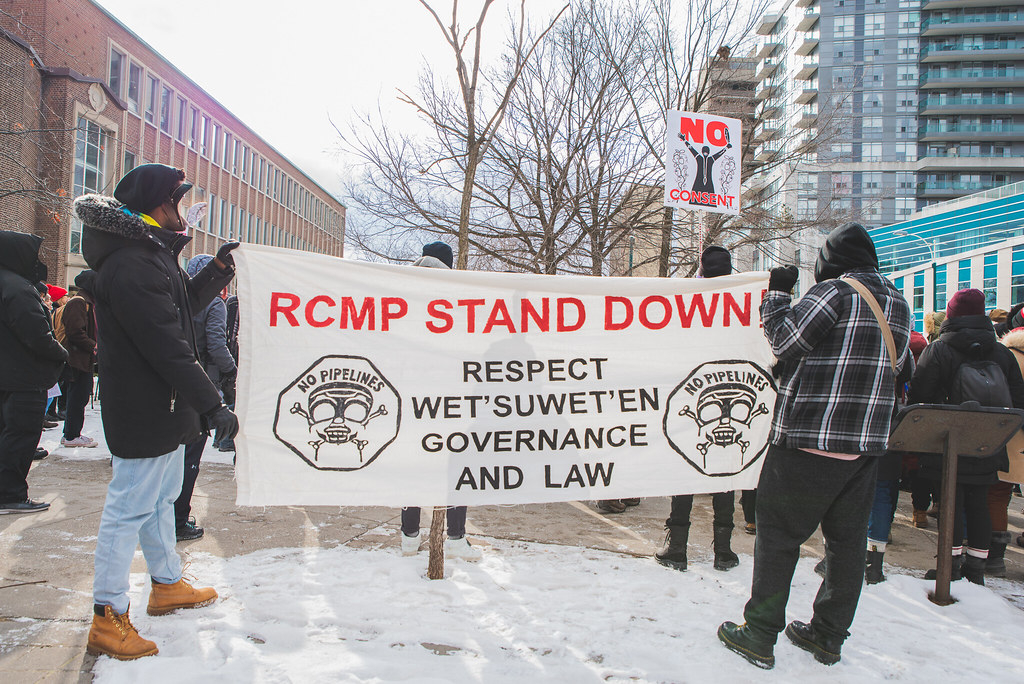 Land defenders hold banner 'RCMP Stand Down' and 'Respect Wet'suwet'en Governance and Law' - Wet'suwet'en Solidarity Event - Rail Yard near Pioneer Village Station Blockaded - Vaughan, Toronto, Ontario - February 15, 2020
