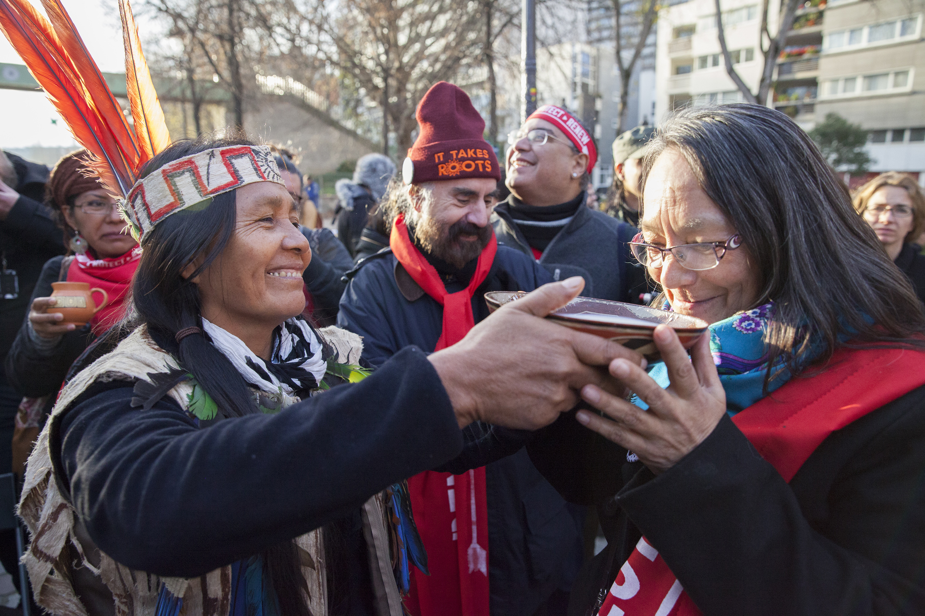 actress_tantoo_cardinal_gets_drink_from_equador_woman_paris_indigenous_rally_climate_talks_cop21_-_mychaylo_prystupa