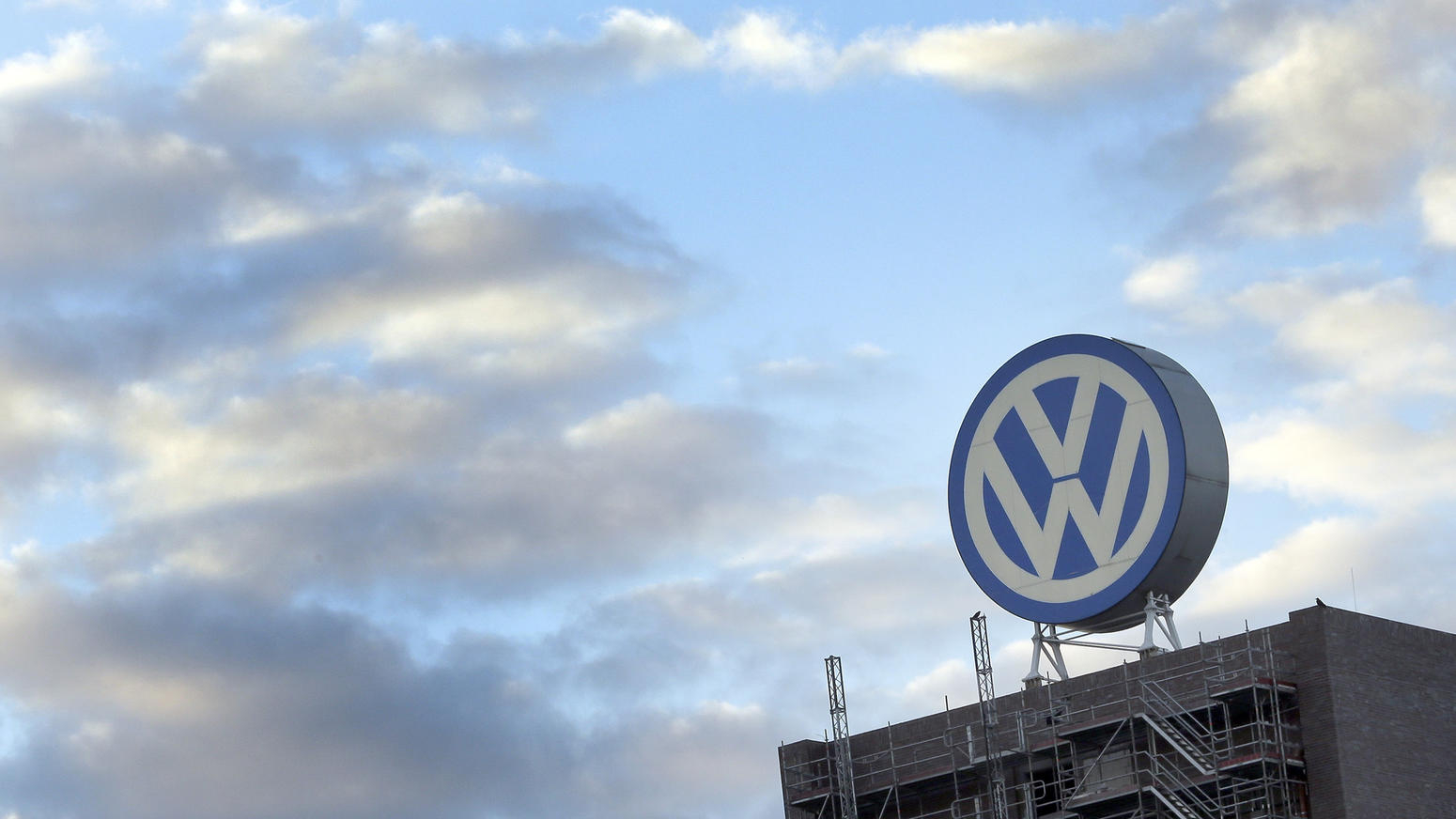 Volkswagens's iconic symbol looms above one of its buildings. Photo by Michael Sohn/Associated Press