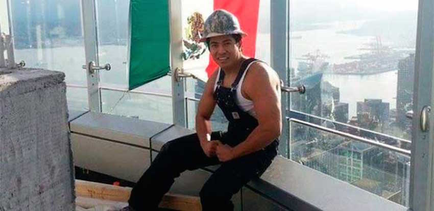 Construction worker Diego Reyna hangs Mexican flag on Vancouver Trump Tower