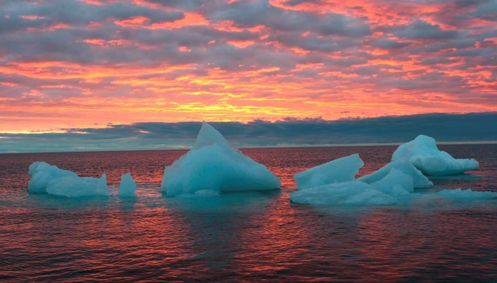 Ice chunks float in the Arctic Ocean as the sun sets near Barrow, Alaska on Sept. 13, 2006.