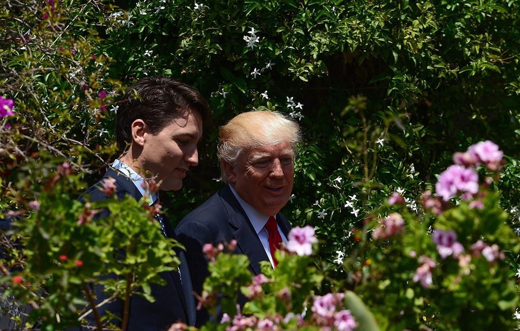 Prime Minister Justin Trudeau and U.S. President Donald Trump walk together during the G7 Summit in Taormina, Italy on Saturday, May 27, 2017. 
