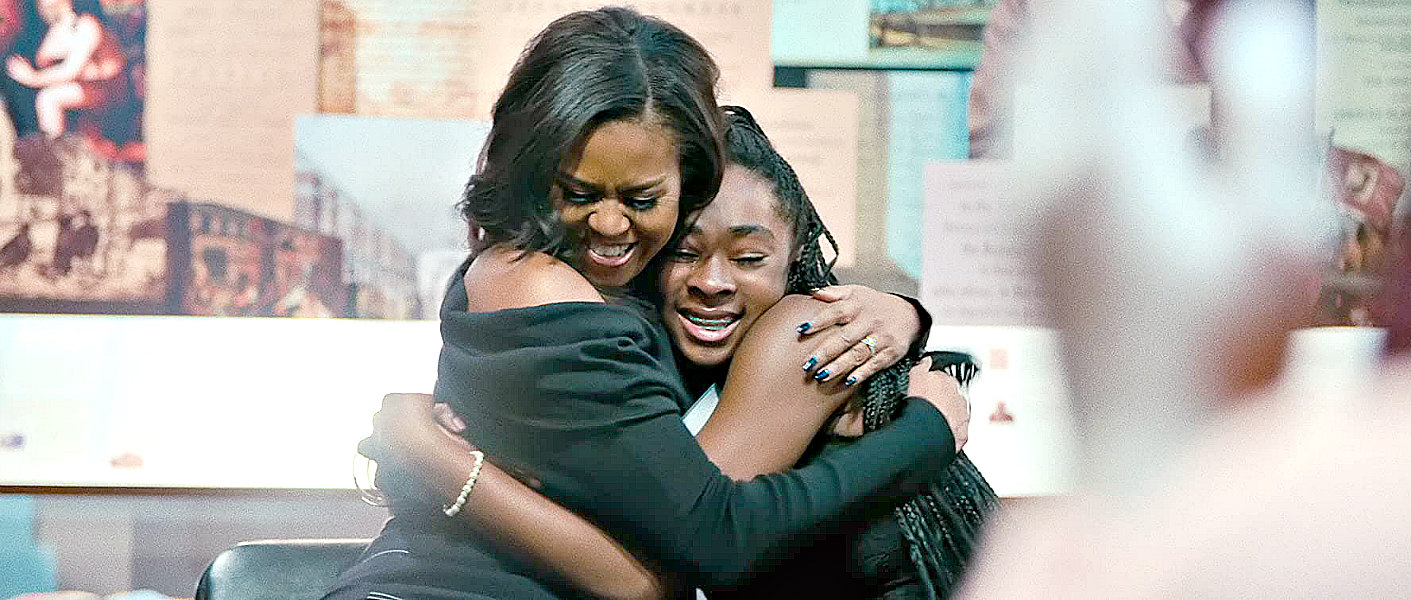 Michelle Obama hugs a fan