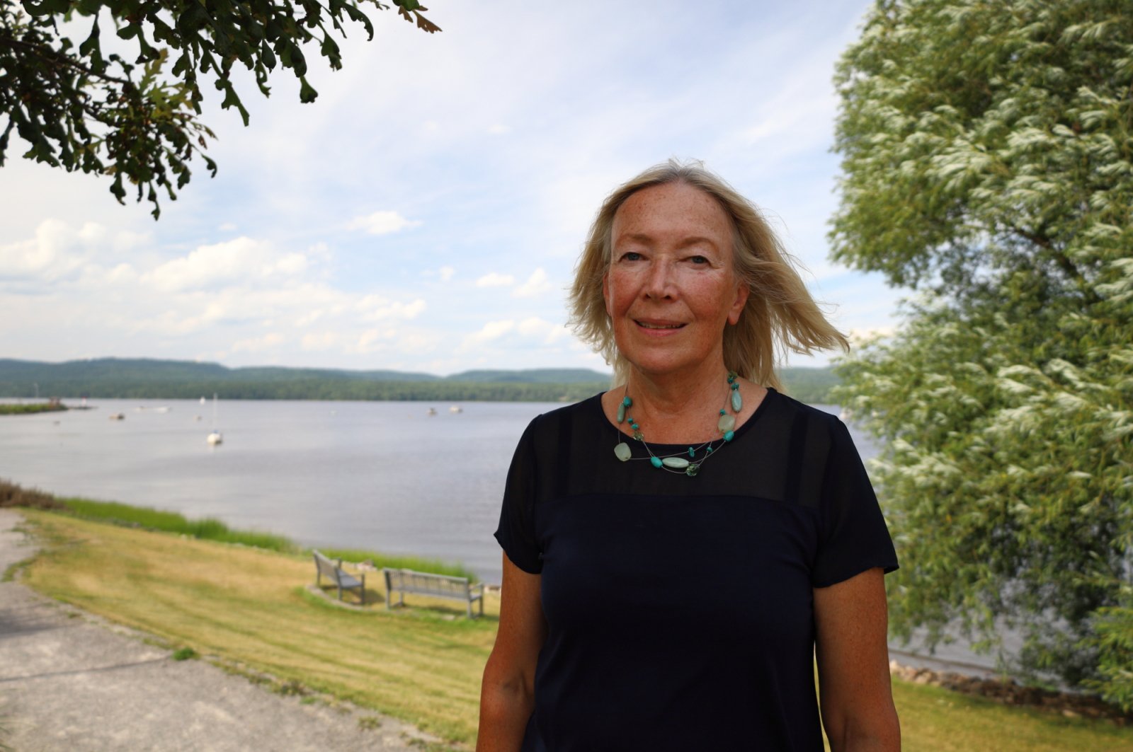Deep River Mayor Suzanne D'Eon stands near a ncie spot at the river on a sunny day