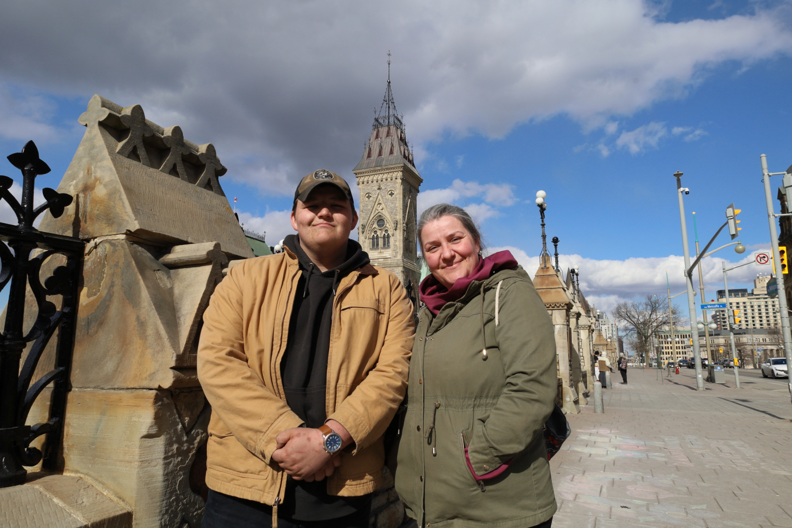 a mother and son pose for a photo in front of Parlaiment Hill in Ottawa, Ont.