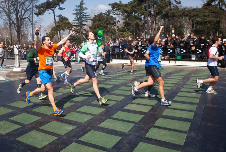 Marathoners cross the finish in Paris on Pavegen's energy-producing tiles. Photo by Pavegen