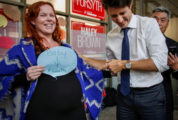 Prime Minister Justin Trudeau, right, laughs as he greets a pregnant supporter during a byelection campaign event in Calgary, Alta., Wednesday, March 1, 2017
