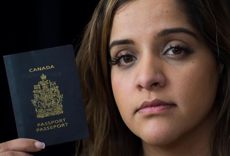 Manpreet Kooner holds up her Canadian passport at her home in Montreal