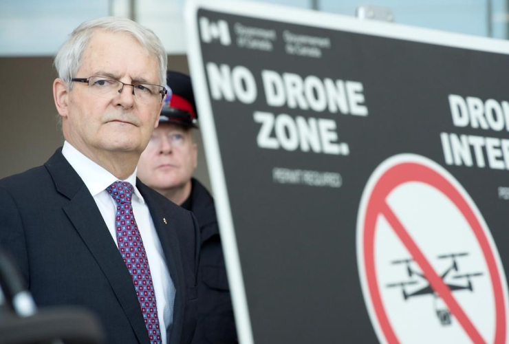 Transport Minister Marc Garneau listens to a question after announcing new safety restrictions on recreational drones at Billy Bishop airport in Toronto on Thursday March 16, 2017