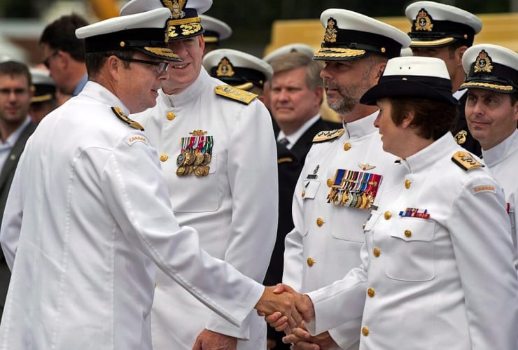 Vice Admiral Mark Norman, left, greets officers at a change of command ceremony in Halifax on July 12, 2013.