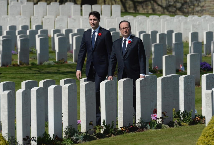 Canadian Prime Minister Justin Trudeau and French President Francois Hollande visit the Cabaret-Rouge cemetery near Vimy Ridge, Sunday, April 9, 2017 near Arras, France.