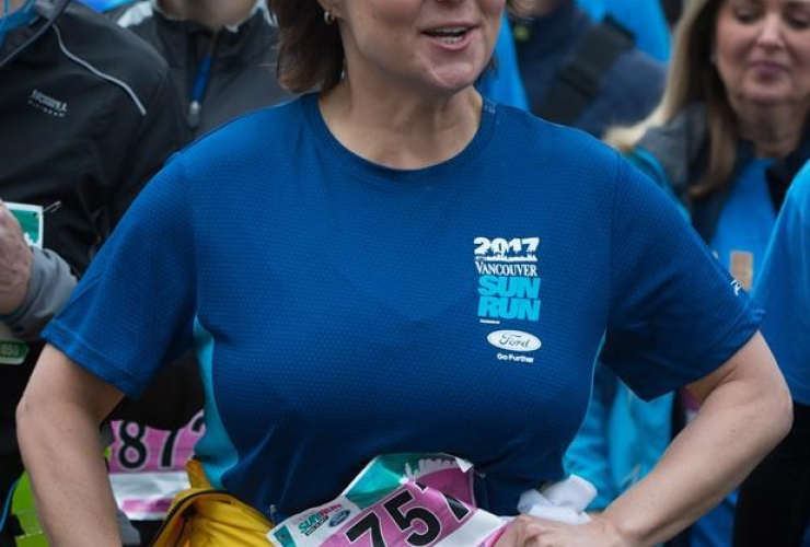 Liberal Leader Christy Clark ties her jacket around her waist as she jogs to the start line to participate in the Sun Run, in Vancouver, B.C., on Sunday April 23, 2017.