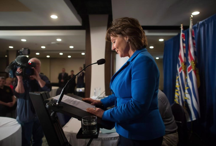 British Columbia Premier Christy Clark pauses to read her notes while addressing MLAs during a caucus meeting at a hotel in Vancouver on May 16, 2017.