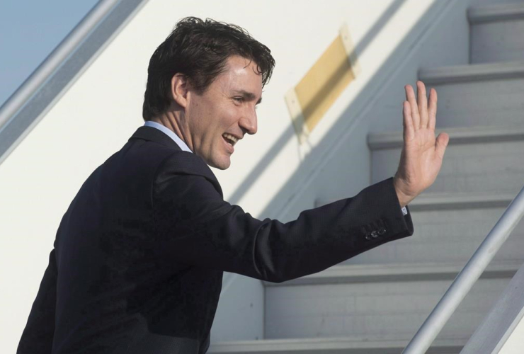 Canadian Prime Minister Justin Trudeau waves as he boards his plane in Strasbourg, France, on Thursday, February 16, 2017. File photo by The Canadian Press/Adrian Wyld