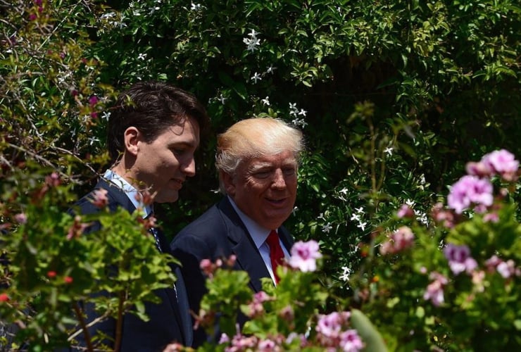 Prime Minister Justin Trudeau and U.S. President Donald Trump walk together during the G7 Summit in Taormina, Italy on Saturday, May 27, 2017. 