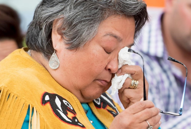 Frances Neumann wipes a tear away as she tells a story about her murdered sister-in-law Mary Johns at the National Inquiry into Missing and Murdered Indigenous Women and Girls taking place in Whitehorse, Yukon, on May 30, 2017. Photo by The Canadian Press