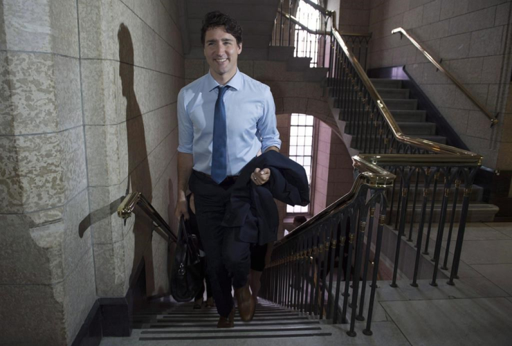Canadian Prime Minister Justin Trudeau makes his way up a flight of stairs to his office on Parliament Hill in Ottawa on June 16, 2017. File photo by The Canadian Press/Adrian Wyld
