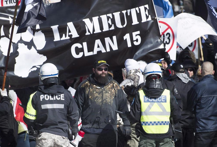 Police hold back far-right protesters during a demonstration in Montreal on March 4, 2017.  