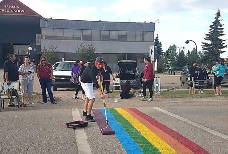 volunteer, paint, colourful crosswalk, Samson Cree Nation administration building, Pride Month,
