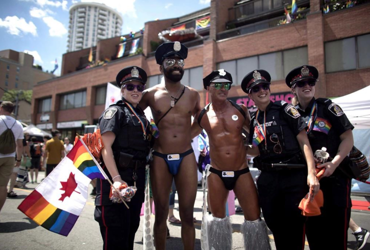 Revellers, photos, police officers, annual Pride Parade, Toronto,