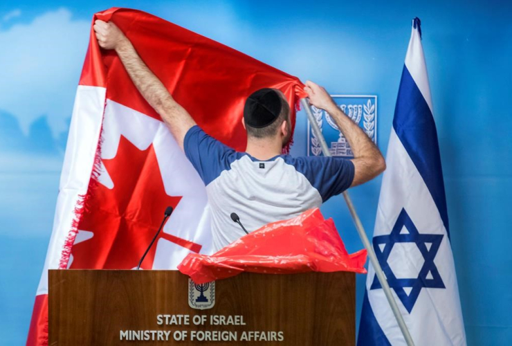 worker, Canadian flag, Israeli flag, Chrystia Freeland, Benjamin Netanyahu, 