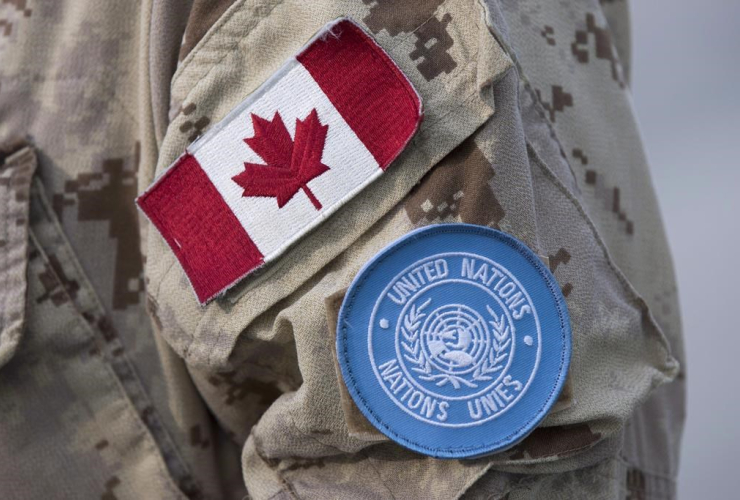 Canadian and UN flags, Canadian soldier's uniform,