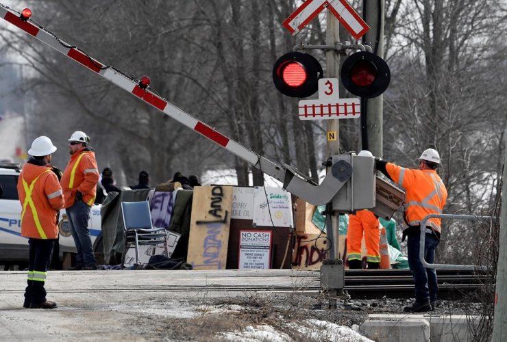CN Railway workers, railroad crossing gate, 