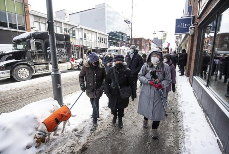 Centretown residents make their way along Bank Street during a “community safety walk,” in reaction to a protest against COVID-19 restrictions in Ottawa that is continuing into its second week, on Feb. 4, 2022. File photo by The Canadian Press/Justin Tang