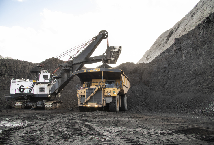 open-pit coal mine with big machienry working in it