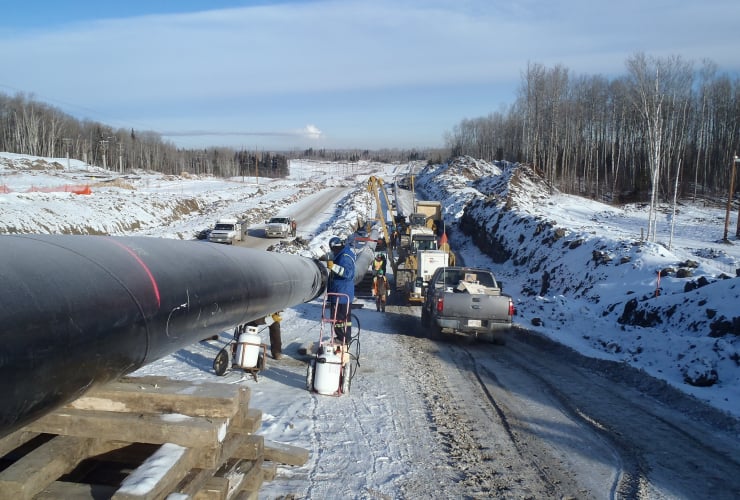 a pipeline with construction workers near it