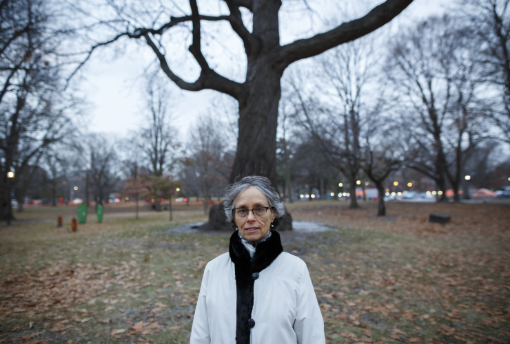 A woman stands in a park