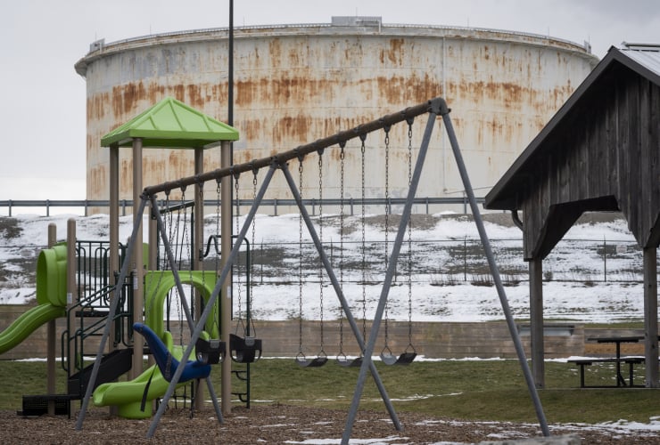 a playground in the foreground and Enbridge oil and gas terminal in the background