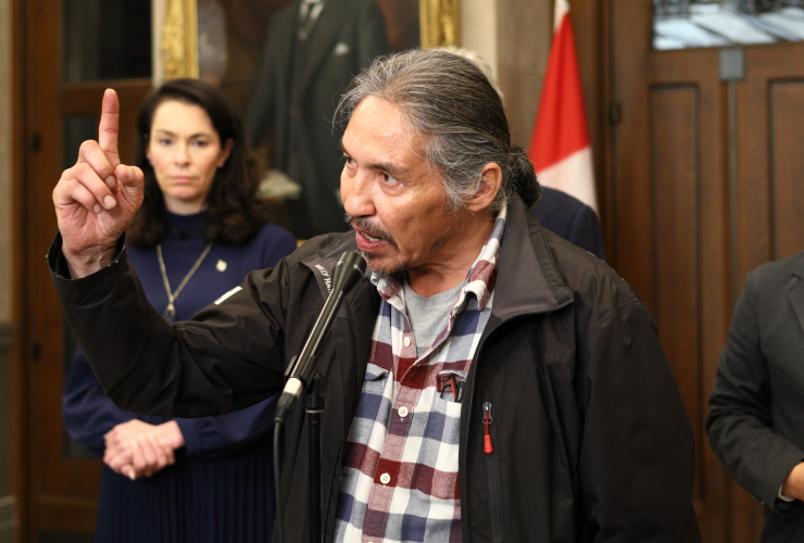 ACFN Chief Allan adam stands, gesturing emphatically with his hand while speaking at a press conference in Ottawa last year